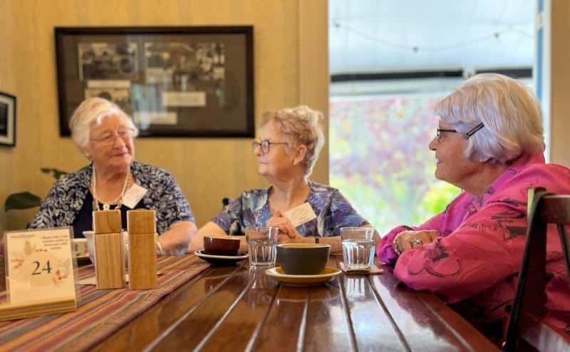 Three friends chatting over coffee