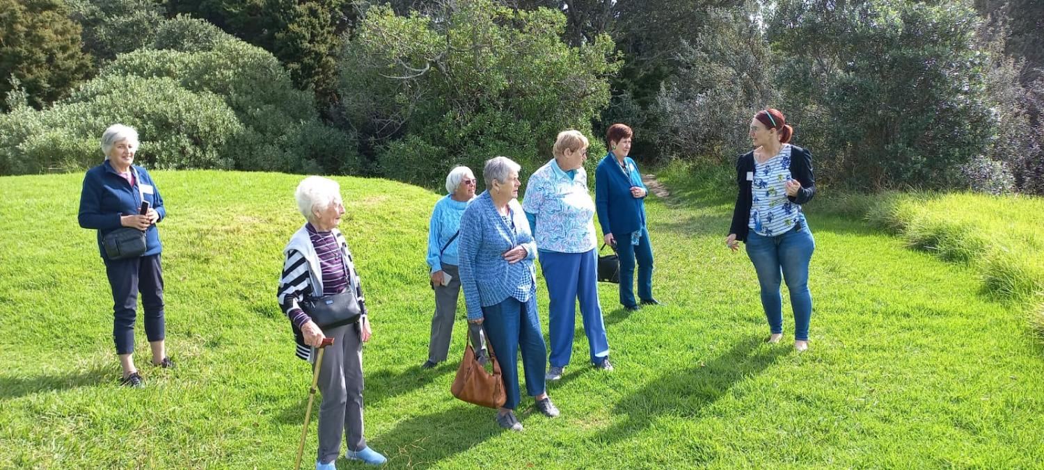 A Silver Rose group walking across a park lawn